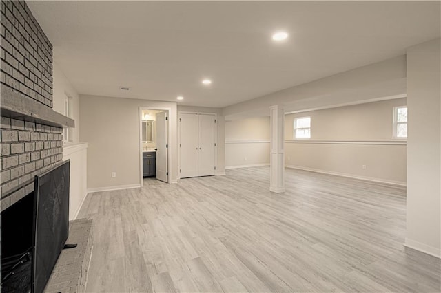 14401 67th St, Parkville, MO 64152 - below grade area with a brick fireplace, recessed lighting, baseboards, and light wood-type flooring