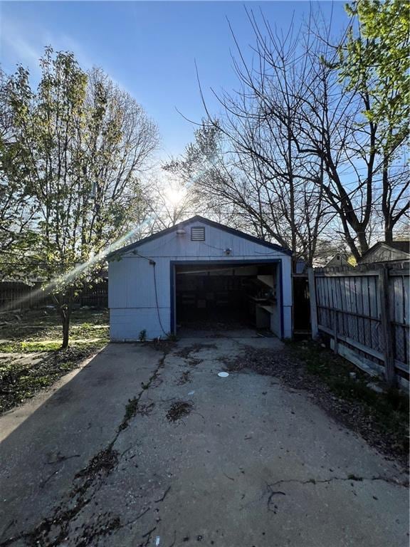 detached garage featuring fence