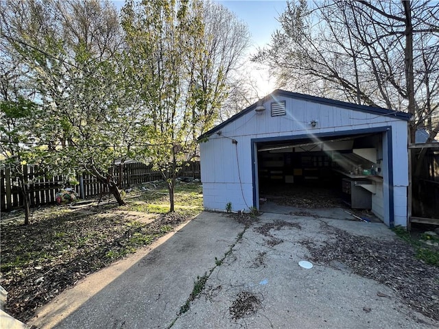 detached garage with driveway and fence