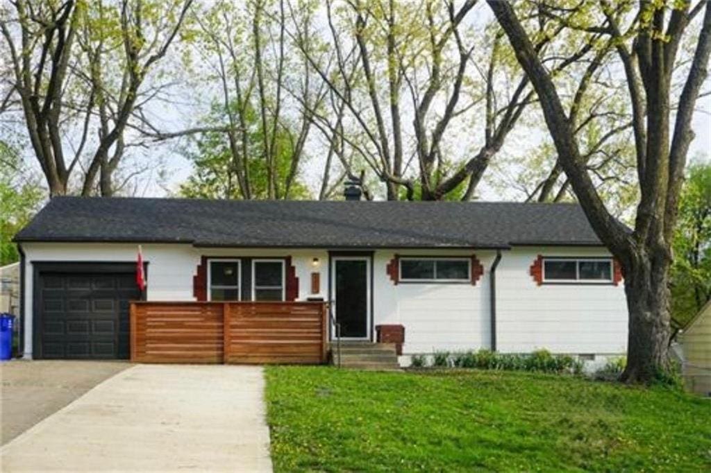 6017 E 149th St, Grandview, MO 64030 - ranch-style home featuring a garage, entry steps, a front lawn, and concrete driveway