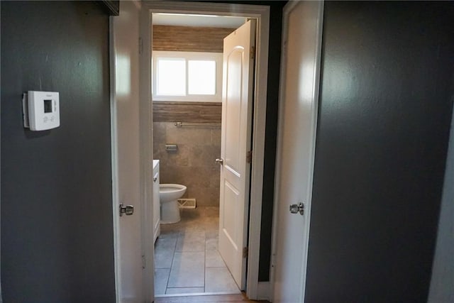 bathroom with tile walls, visible vents, tile patterned floors, and toilet