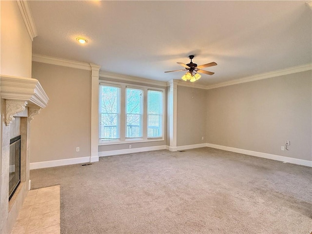unfurnished living room with baseboards, carpet, ceiling fan, ornamental molding, and a fireplace