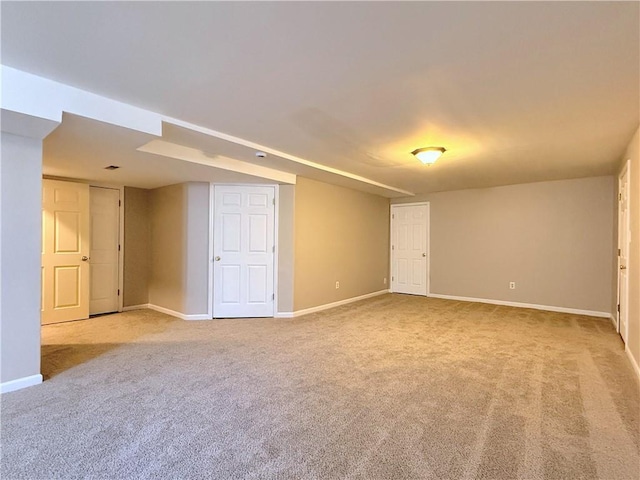 unfurnished room with carpet flooring and baseboards