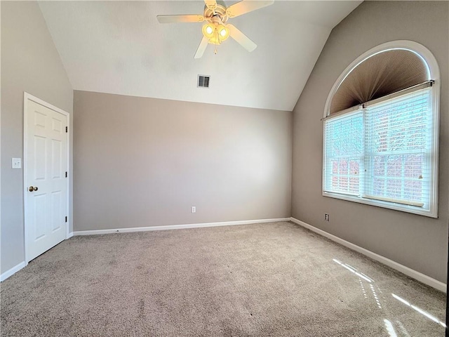 spare room with visible vents, lofted ceiling, carpet floors, and ceiling fan