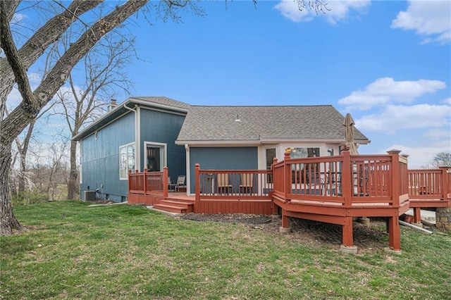 back of house with a wooden deck, roof with shingles, a yard, and central AC unit