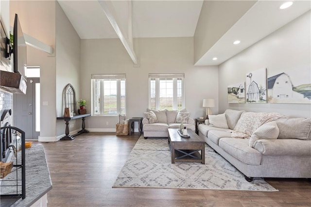 living room with high vaulted ceiling, dark wood-type flooring, and recessed lighting