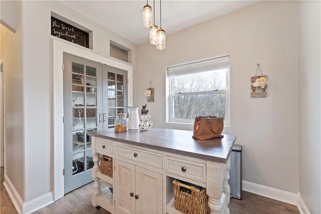 interior space featuring baseboards, dark wood-style floors, and french doors