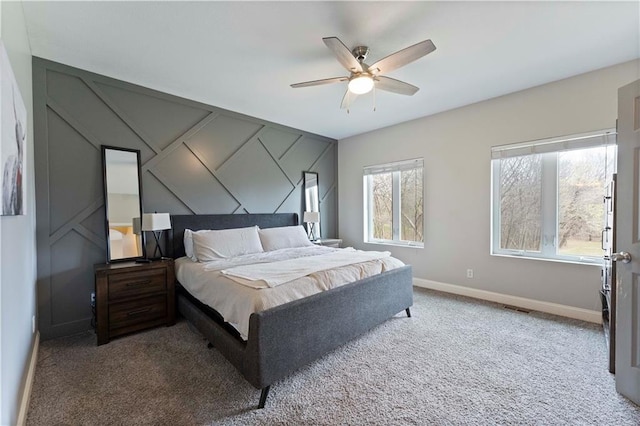 carpeted bedroom with visible vents, baseboards, and ceiling fan