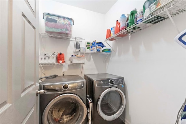 laundry room with washer and clothes dryer and laundry area