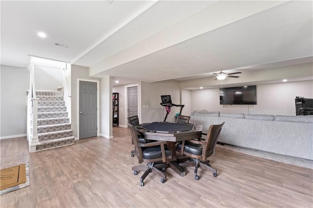 rec room with wood finished floors, visible vents, a ceiling fan, and baseboards