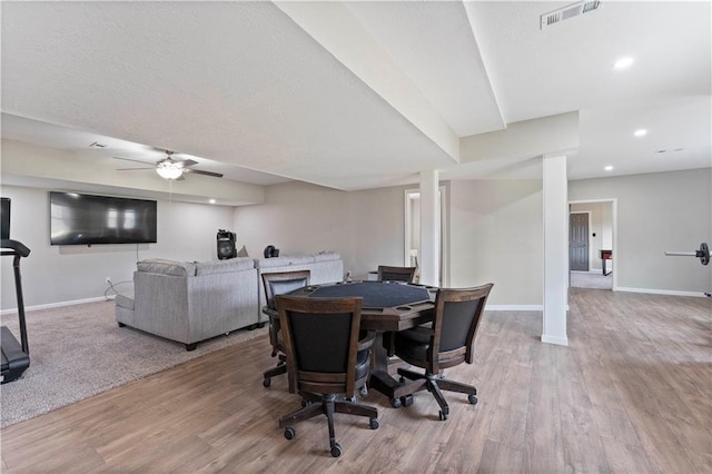 dining room featuring wood finished floors, visible vents, and baseboards