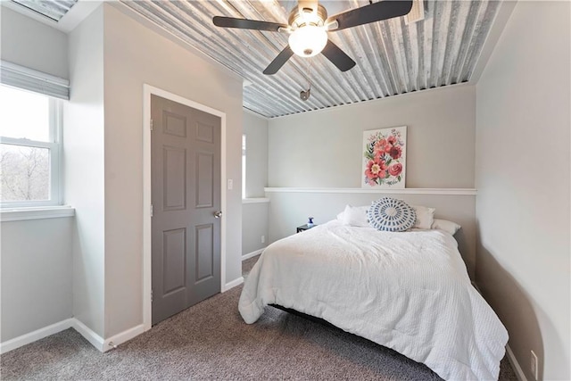 bedroom featuring carpet floors, a ceiling fan, and baseboards