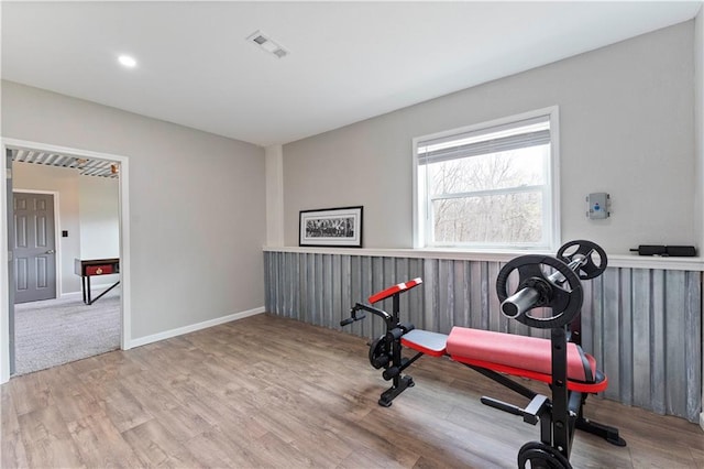 exercise room featuring baseboards, wood finished floors, visible vents, and recessed lighting
