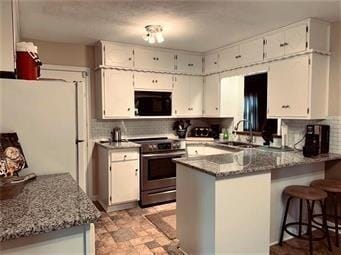 kitchen featuring white cabinetry, stainless steel electric range, a sink, freestanding refrigerator, and a peninsula