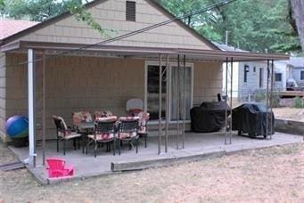 back of house featuring a patio area and a carport