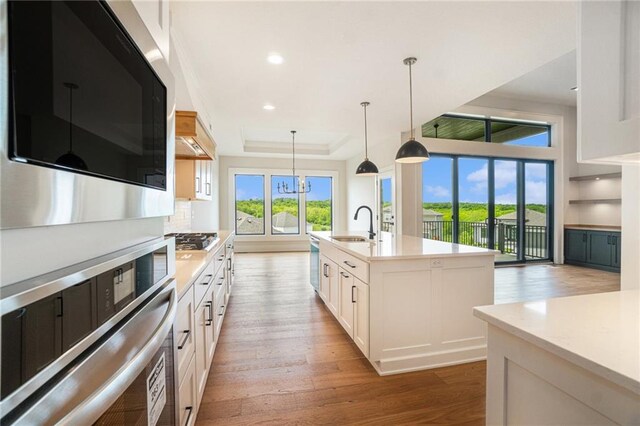 2317 SW Morris Dr, Lees Summit, MO 64082 - kitchen featuring stainless steel appliances, light wood-style flooring, light countertops, white cabinetry, and recessed lighting
