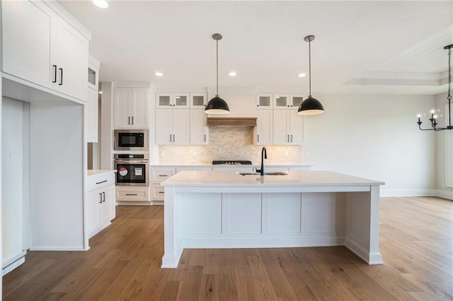 2317 SW Morris Dr, Lees Summit, MO 64082 - kitchen with stainless steel oven, a sink, light wood-style flooring, decorative backsplash, and recessed lighting