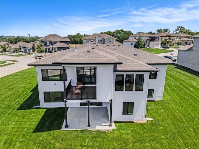 2317 SW Morris Dr, Lees Summit, MO 64082 - back of house with a shingled roof, a residential view, a yard, and a patio area