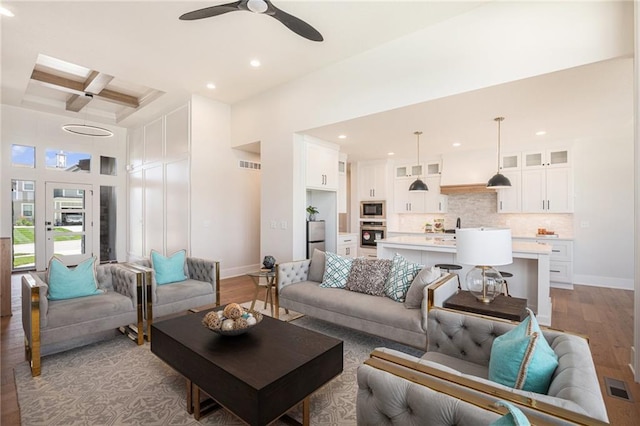 2317 SW Morris Dr, Lees Summit, MO 64082 - living room featuring light wood finished floors, coffered ceiling, ceiling fan, recessed lighting, and beam ceiling