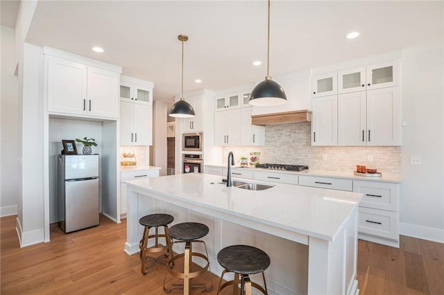 2317 SW Morris Dr, Lees Summit, MO 64082 - kitchen featuring stainless steel appliances, decorative backsplash, light wood-style floors, and recessed lighting