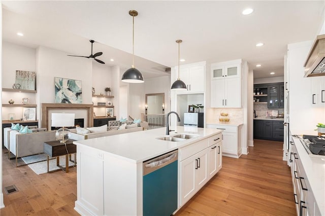2317 SW Morris Dr, Lees Summit, MO 64082 - kitchen with dishwasher, light wood finished floors, custom range hood, ceiling fan, and recessed lighting