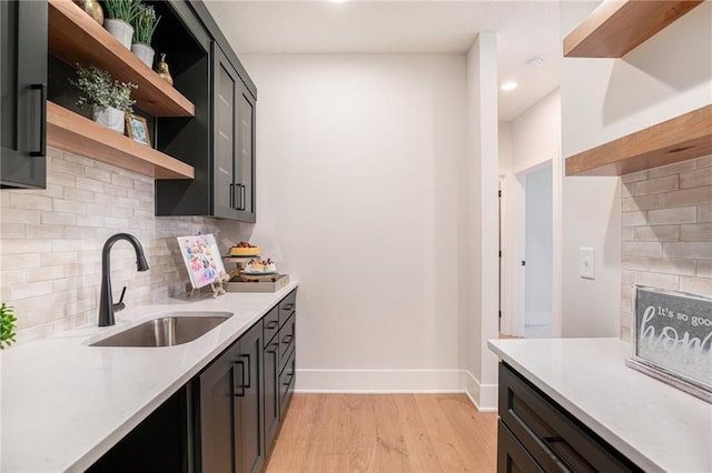 2317 SW Morris Dr, Lees Summit, MO 64082 - kitchen featuring open shelves, light wood finished floors, backsplash, recessed lighting, and light stone counters