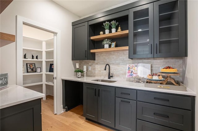 2317 SW Morris Dr, Lees Summit, MO 64082 - indoor wet bar featuring light wood-style floors and tasteful backsplash