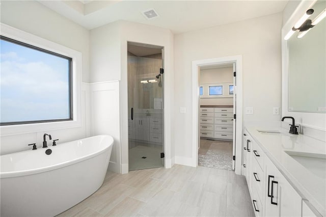 2317 SW Morris Dr, Lees Summit, MO 64082 - full bath featuring a stall shower, double vanity, a soaking tub, and a walk in closet