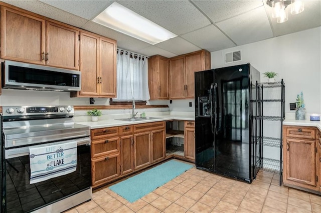 134 Timber Valley Dr, Linn Valley, KS 66040 - kitchen featuring a sink, appliances with stainless steel finishes, a drop ceiling, and light countertops