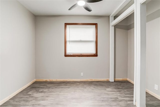 134 Timber Valley Dr, Linn Valley, KS 66040 - unfurnished bedroom with baseboards, ceiling fan, and wood finished floors