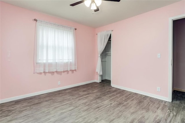 134 Timber Valley Dr, Linn Valley, KS 66040 - unfurnished bedroom featuring baseboards, ceiling fan, wood finished floors, and a closet