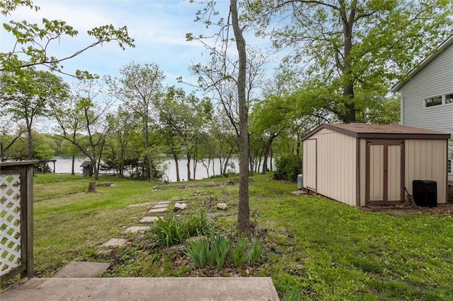 134 Timber Valley Dr, Linn Valley, KS 66040 - view of yard featuring an outdoor structure, a water view, and a storage shed
