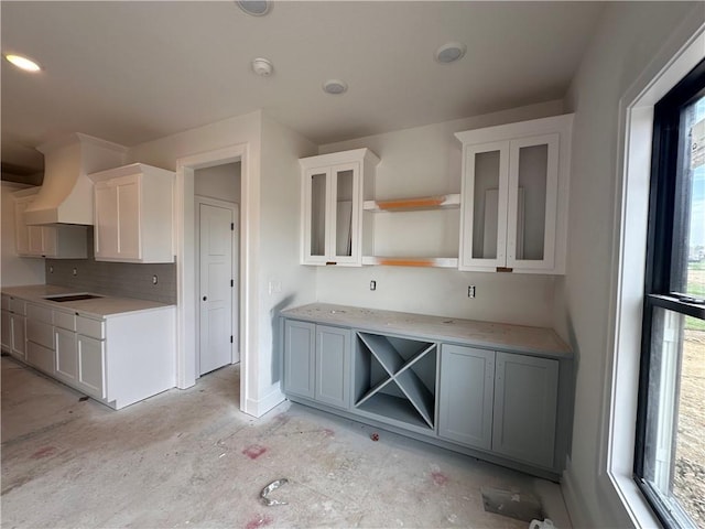 kitchen with backsplash, glass insert cabinets, open shelves, and white cabinets