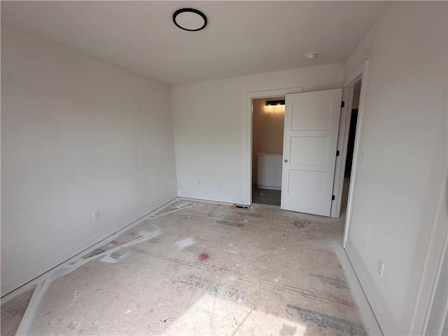 spare room with baseboards
