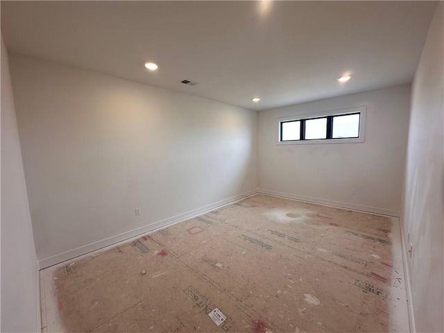 empty room featuring recessed lighting, visible vents, and baseboards