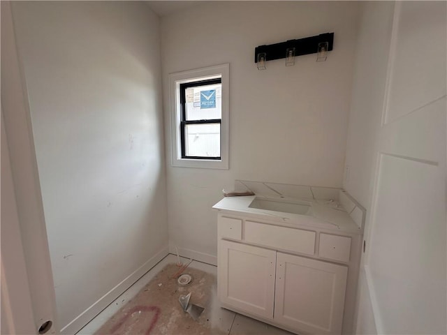 bathroom with vanity and baseboards