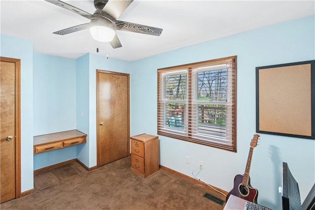unfurnished bedroom with carpet flooring, visible vents, baseboards, and ceiling fan