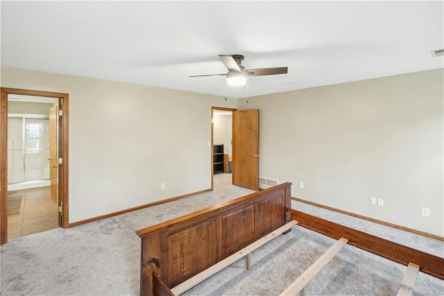 unfurnished bedroom featuring carpet flooring, baseboards, a ceiling fan, and visible vents