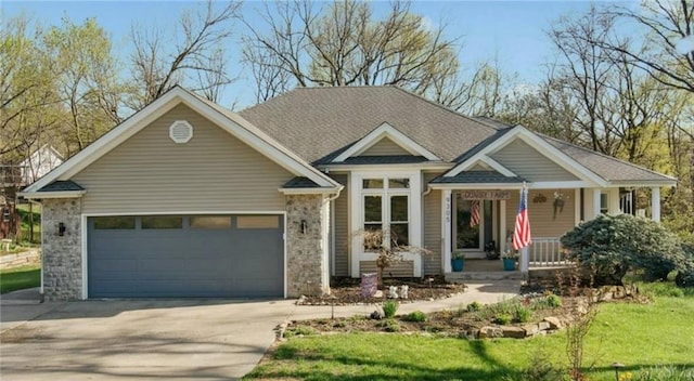 9305 NW 80th St, Weatherby Lake, MO 64152 - view of front of property with driveway, covered porch, a garage, a front yard, and brick siding