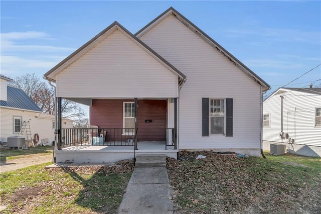 208 E 5th St, Carrollton, MO 64633 - bungalow-style house with cooling unit and a porch