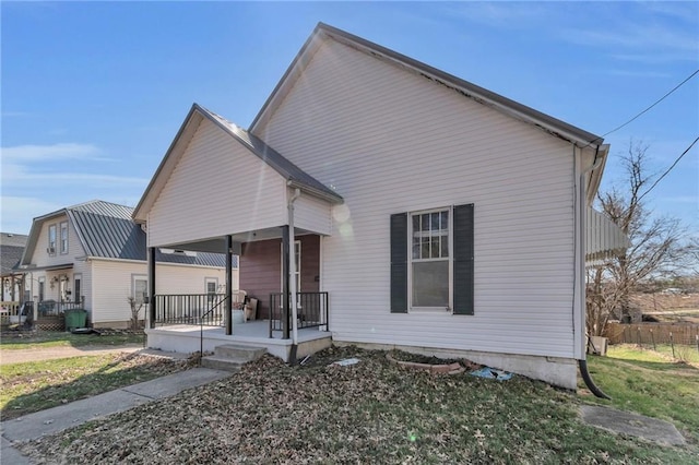 208 E 5th St, Carrollton, MO 64633 - view of front of home featuring covered porch