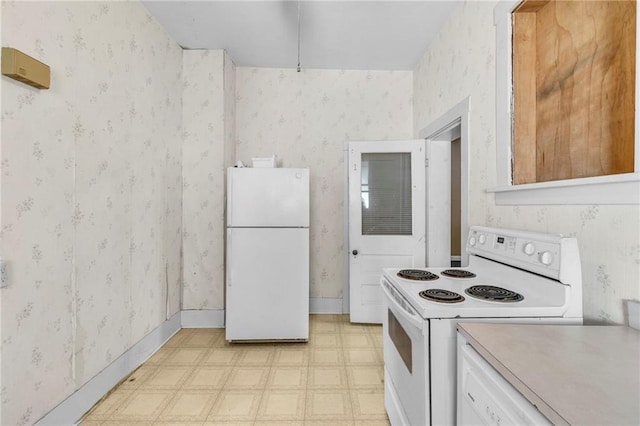 208 E 5th St, Carrollton, MO 64633 - kitchen featuring wallpapered walls, white appliances, light countertops, baseboards, and light floors