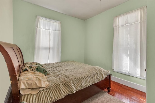 208 E 5th St, Carrollton, MO 64633 - bedroom with baseboards and wood finished floors
