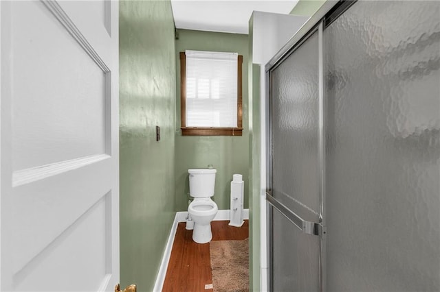 208 E 5th St, Carrollton, MO 64633 - full bathroom featuring toilet, an enclosed shower, wood finished floors, and baseboards