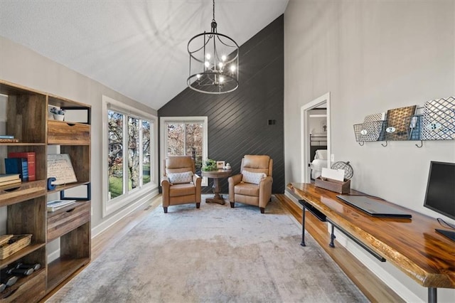 office with high vaulted ceiling, a notable chandelier, baseboards, and wood finished floors