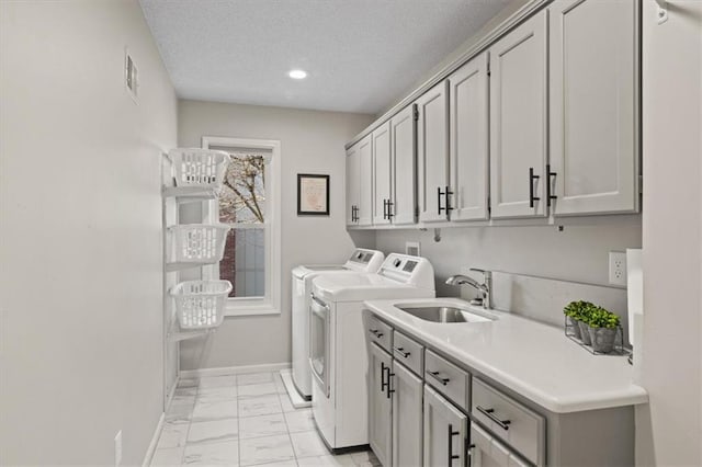 laundry area with baseboards, a sink, independent washer and dryer, cabinet space, and marble finish floor