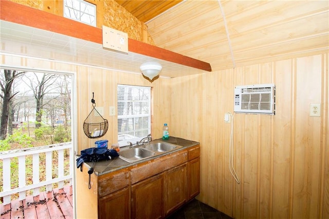 3819 Dogwood Dr, Stover, MO 65078 - kitchen with brown cabinetry, a wall mounted AC, wooden walls, and a sink