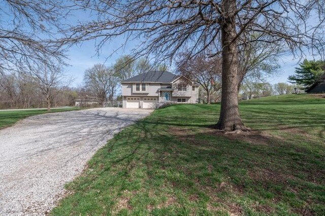 6620 NW 136th St, Kansas City, MO 64164 - view of front of house featuring a front yard, driveway, and a garage