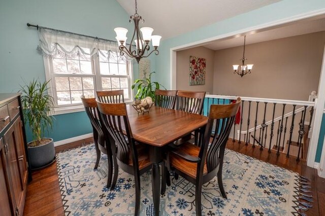 6620 NW 136th St, Kansas City, MO 64164 - dining area featuring wood finished floors, a notable chandelier, lofted ceiling, and baseboards