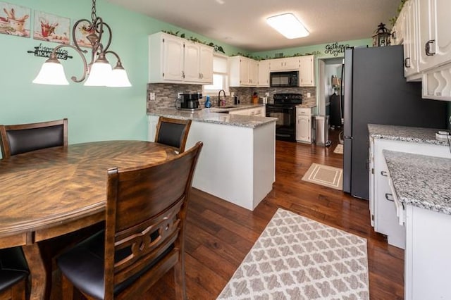 6620 NW 136th St, Kansas City, MO 64164 - kitchen with dark wood-type flooring, tasteful backsplash, white cabinetry, black appliances, and a sink